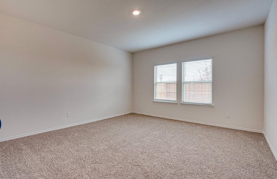 1614 Potomac Lane Blue Ridge, TX 75424 - Photo 6 of 18 Spacious room featuring neutral carpet flooring, light-toned walls, and two windows with horizontal blinds