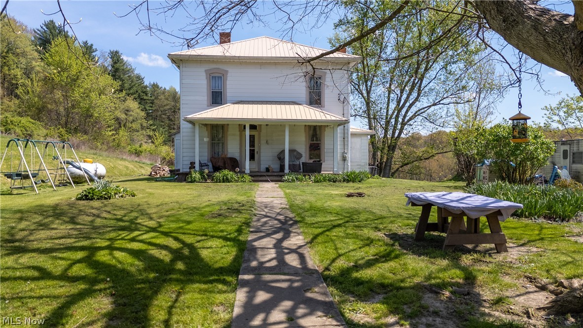 79405 Freeport Tippecanoe Road Tippecanoe, OH 44699 - Photo 2 of 42 Back of property with a porch and a lawn