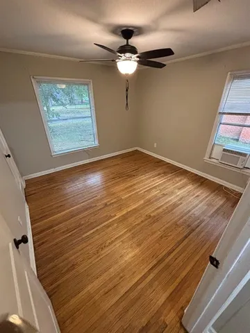 wooden floor in an empty room with a window