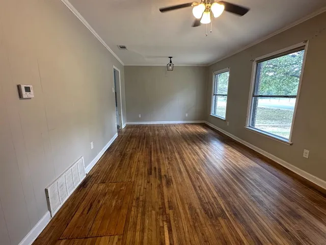 wooden floor in an empty room with a window