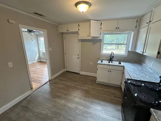 a kitchen with a sink appliances and cabinets