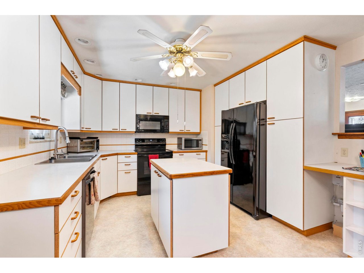 300 Ranch Acres Drive Loveland, CO 80538 - Photo 10 of 38 a kitchen with stainless steel appliances a refrigerator sink and cabinets