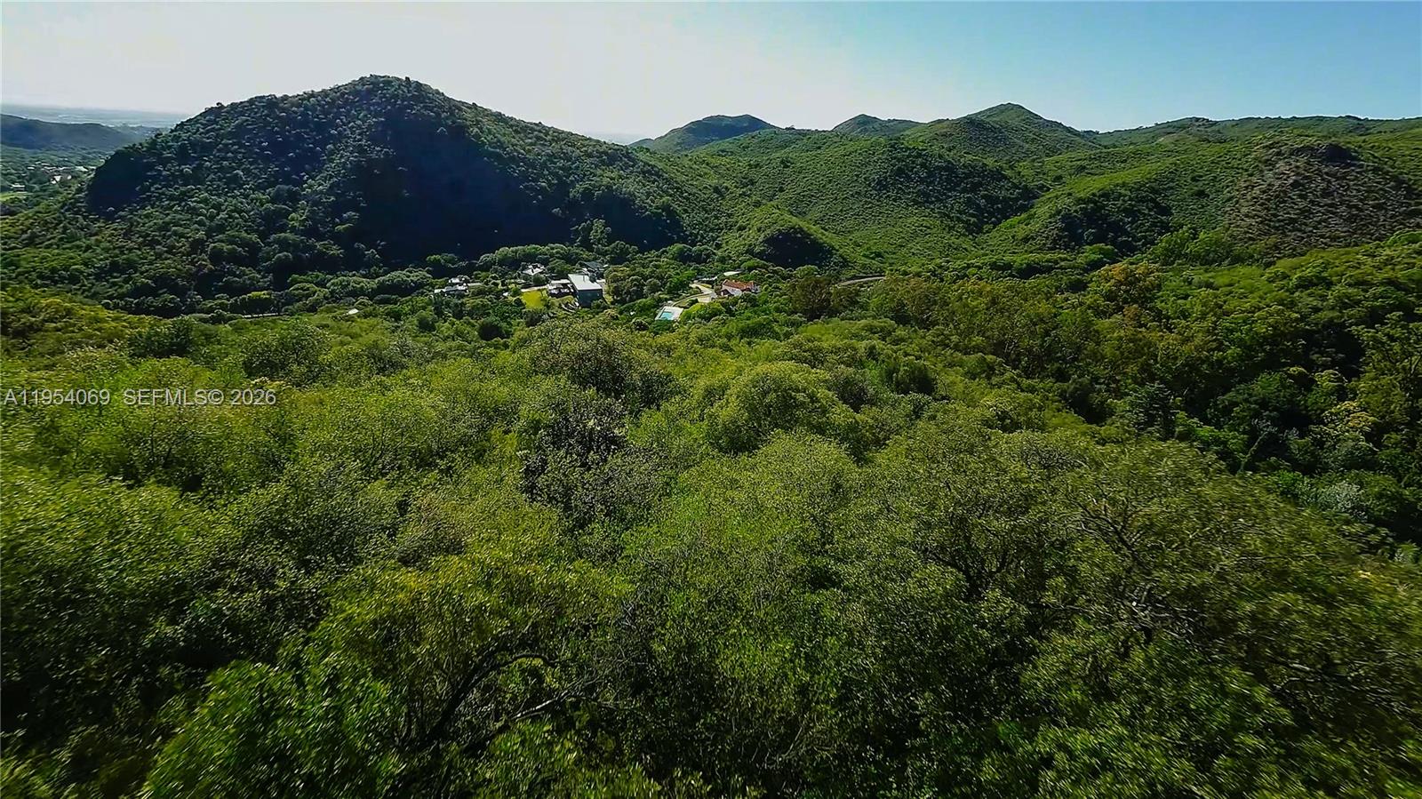 1 Segundo Paredon undefined, undefined 5186 - Photo 23 of 57 a view of a house with a lush green forest