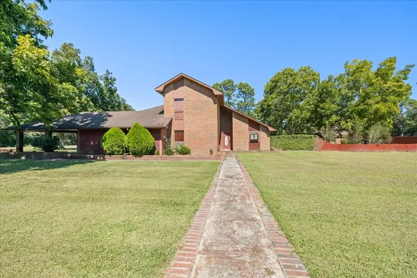 a front view of a house with yard