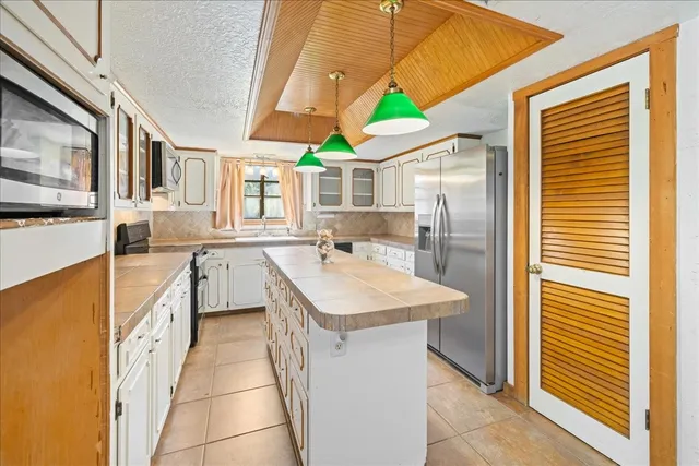 a view of a livingroom with furniture and floor to ceiling window