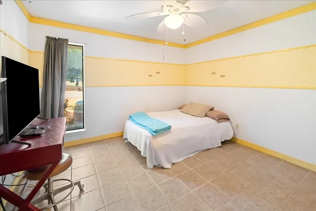 a bathroom with a granite countertop sink mirror vanity and toilet