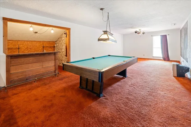 a bathroom with a sink vanity granite and shower