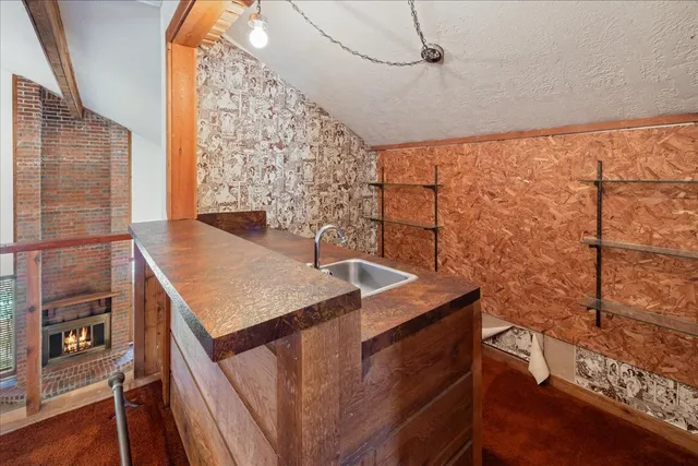 a view of staircase with railing and a window