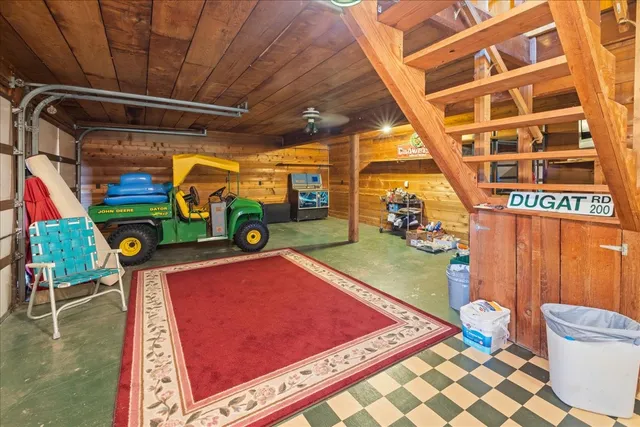 a view of a chairs and table in the patio with a barbeque grill
