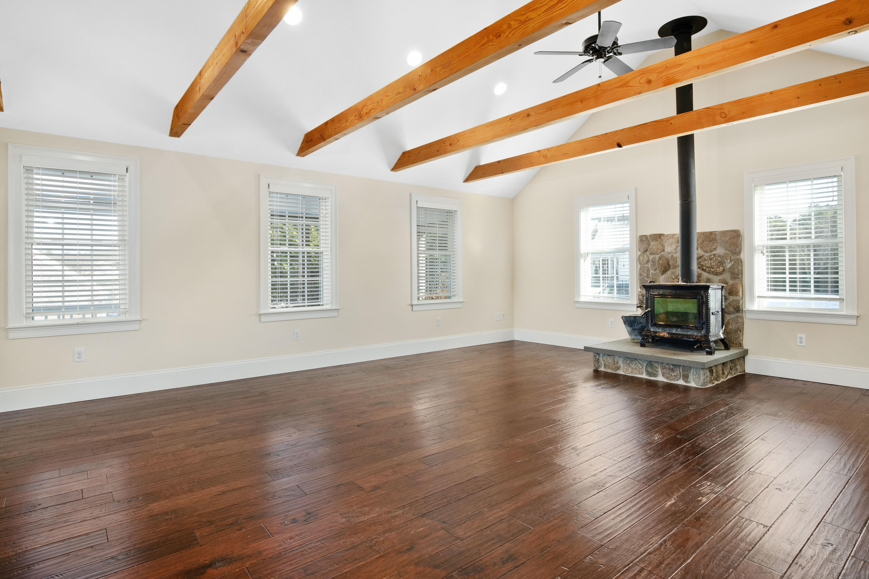 141 Bog Road Marstons Mills, MA 02648 - Photo 12 of 59 a view of an empty room with wooden floor and a window