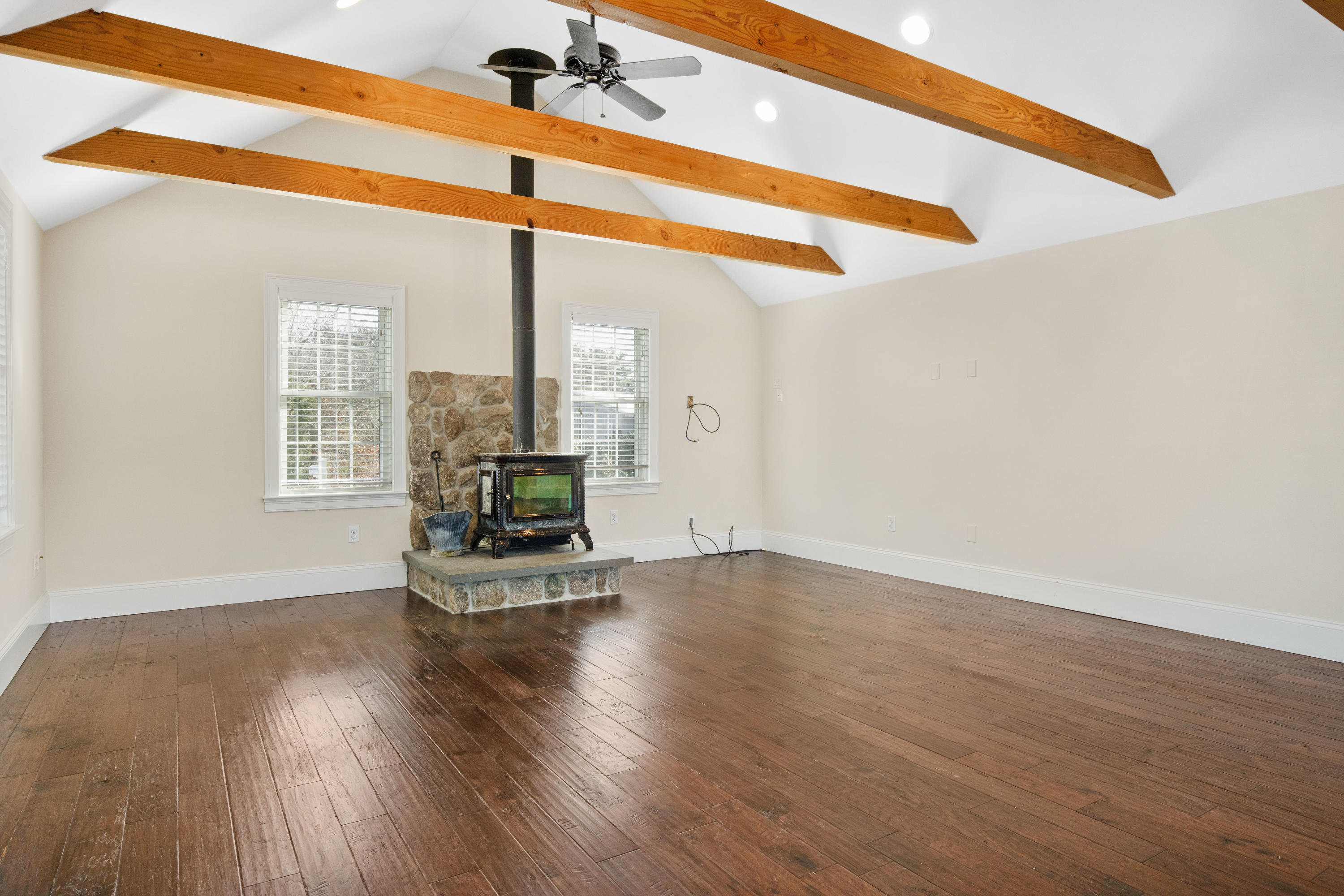 141 Bog Road Marstons Mills, MA 02648 - Photo 13 of 59 a view of an empty room with wooden floor and a window