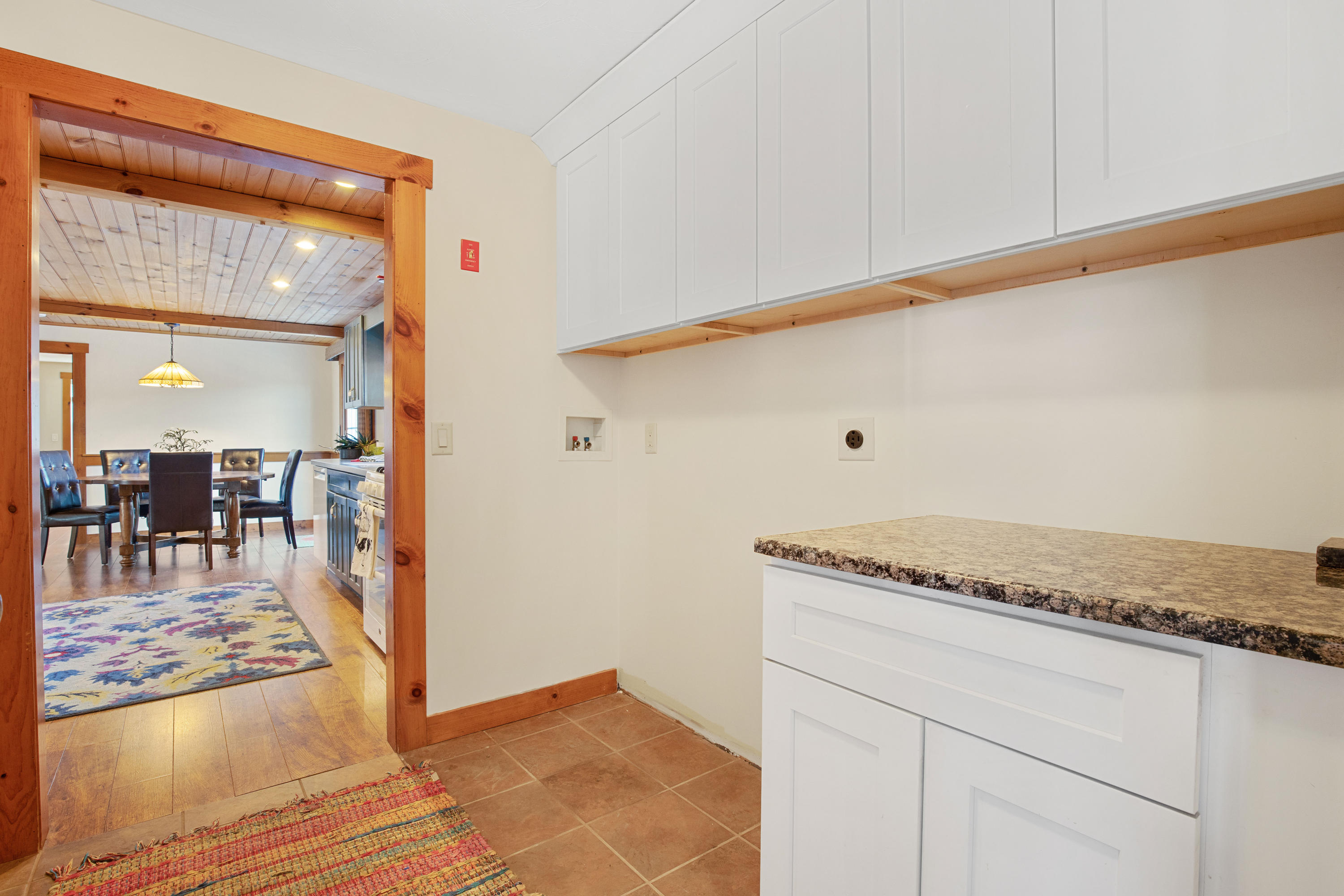 141 Bog Road Marstons Mills, MA 02648 - Photo 17 of 59 a view of a hallway with granite countertop a rug a stove and a wooden floor