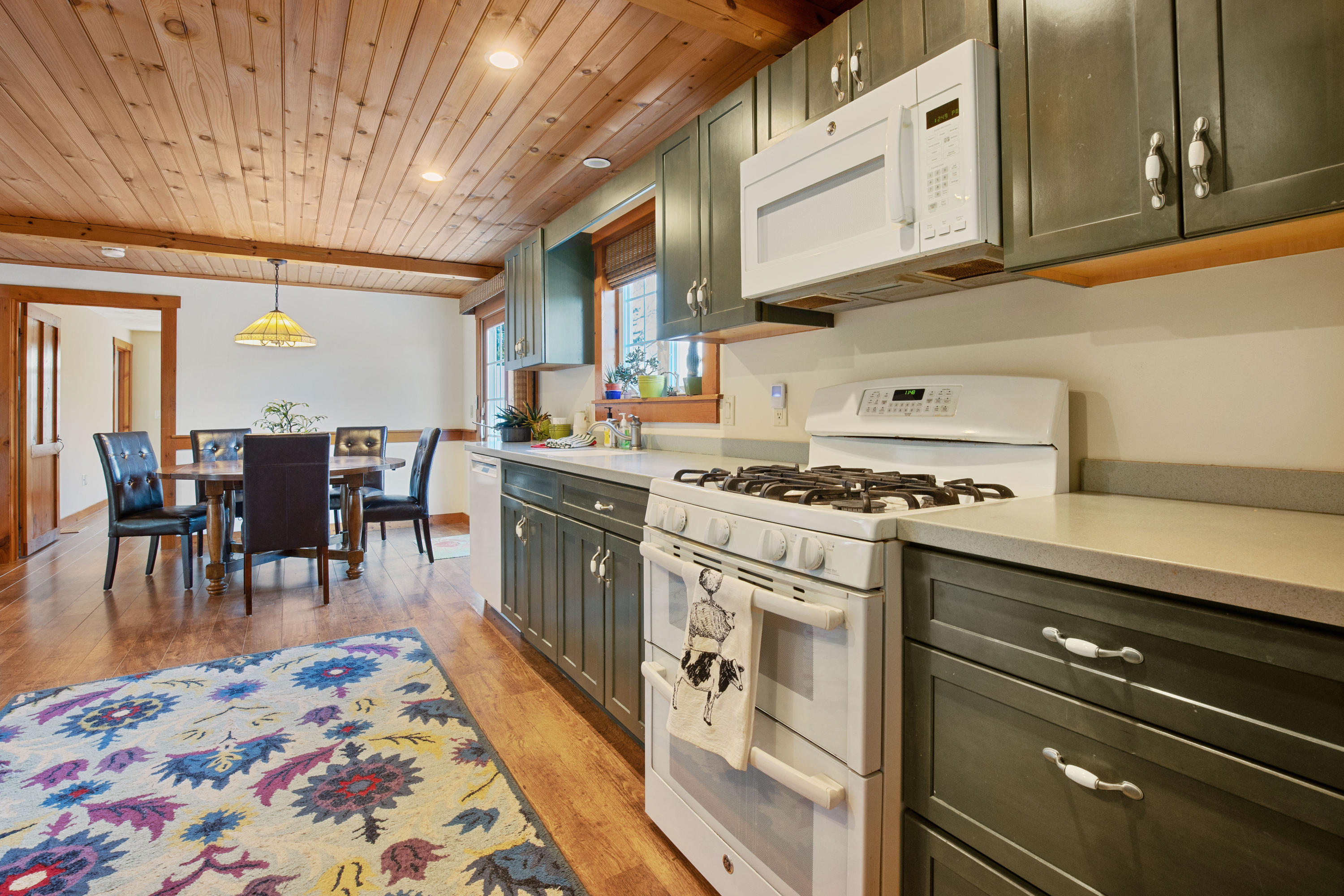 141 Bog Road Marstons Mills, MA 02648 - Photo 18 of 59 a open kitchen with stainless steel appliances granite countertop a stove and a dining table