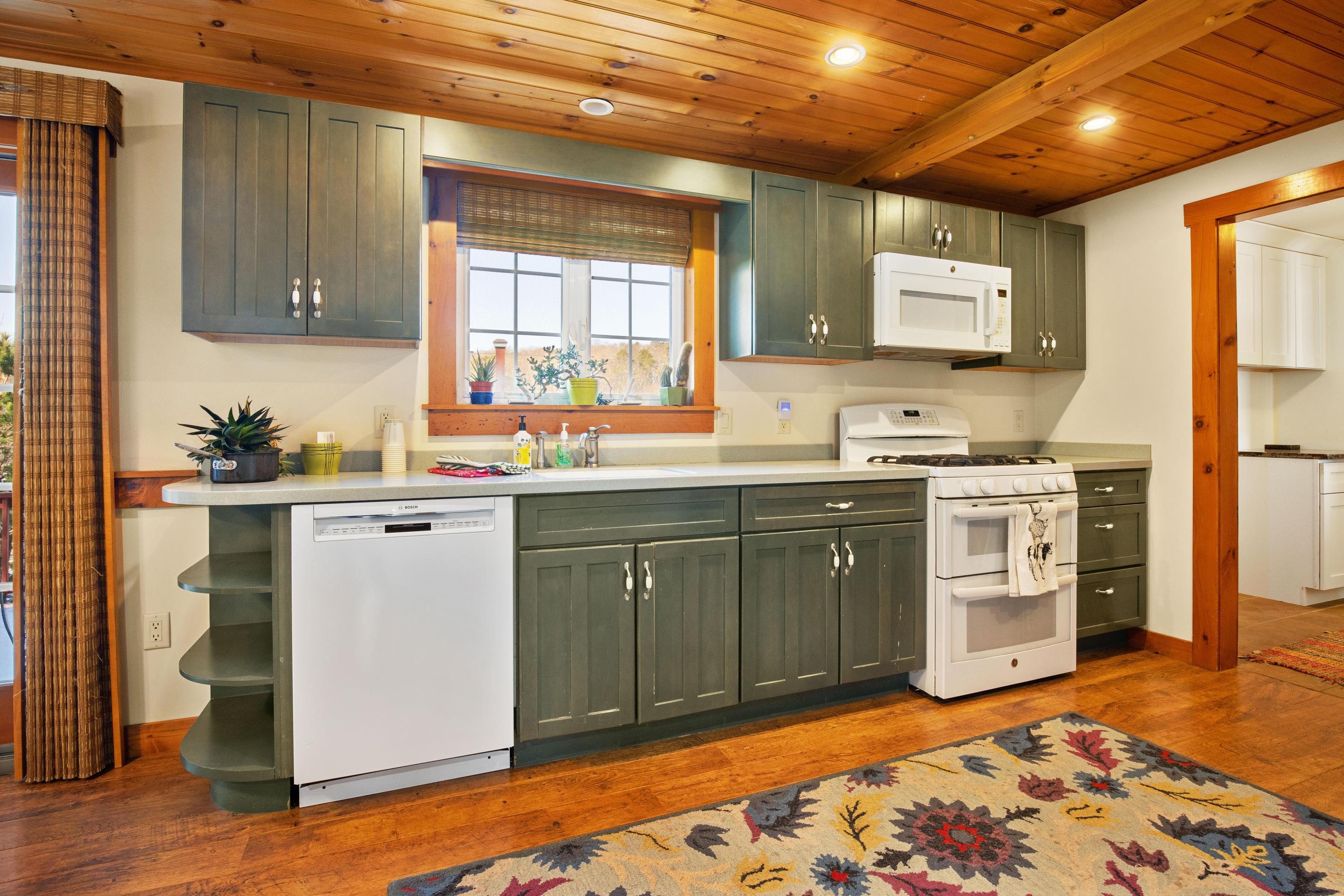 141 Bog Road Marstons Mills, MA 02648 - Photo 19 of 59 a kitchen with a sink stove and cabinets
