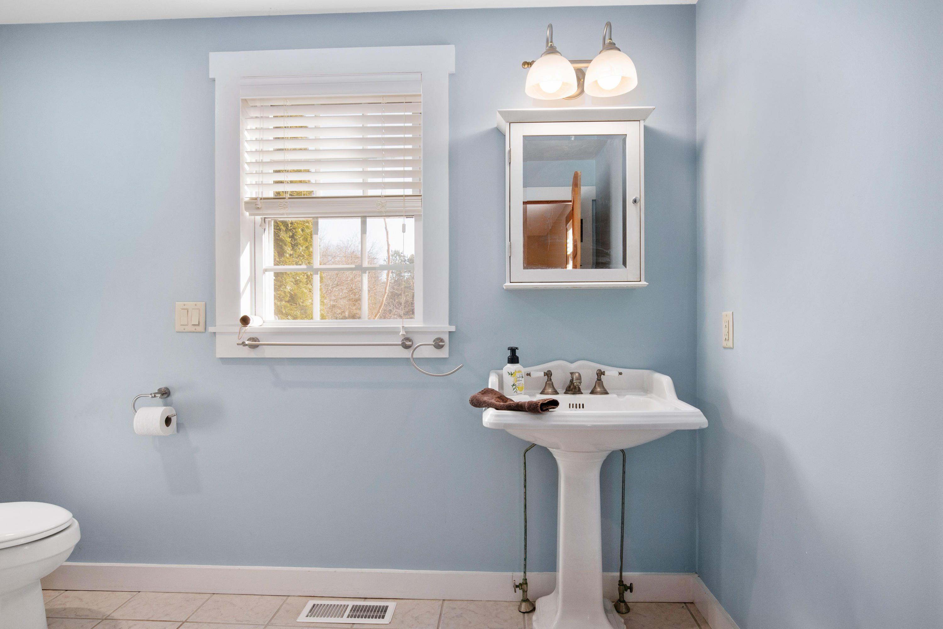 141 Bog Road Marstons Mills, MA 02648 - Photo 29 of 59 a bathroom with a sink a mirror and a window