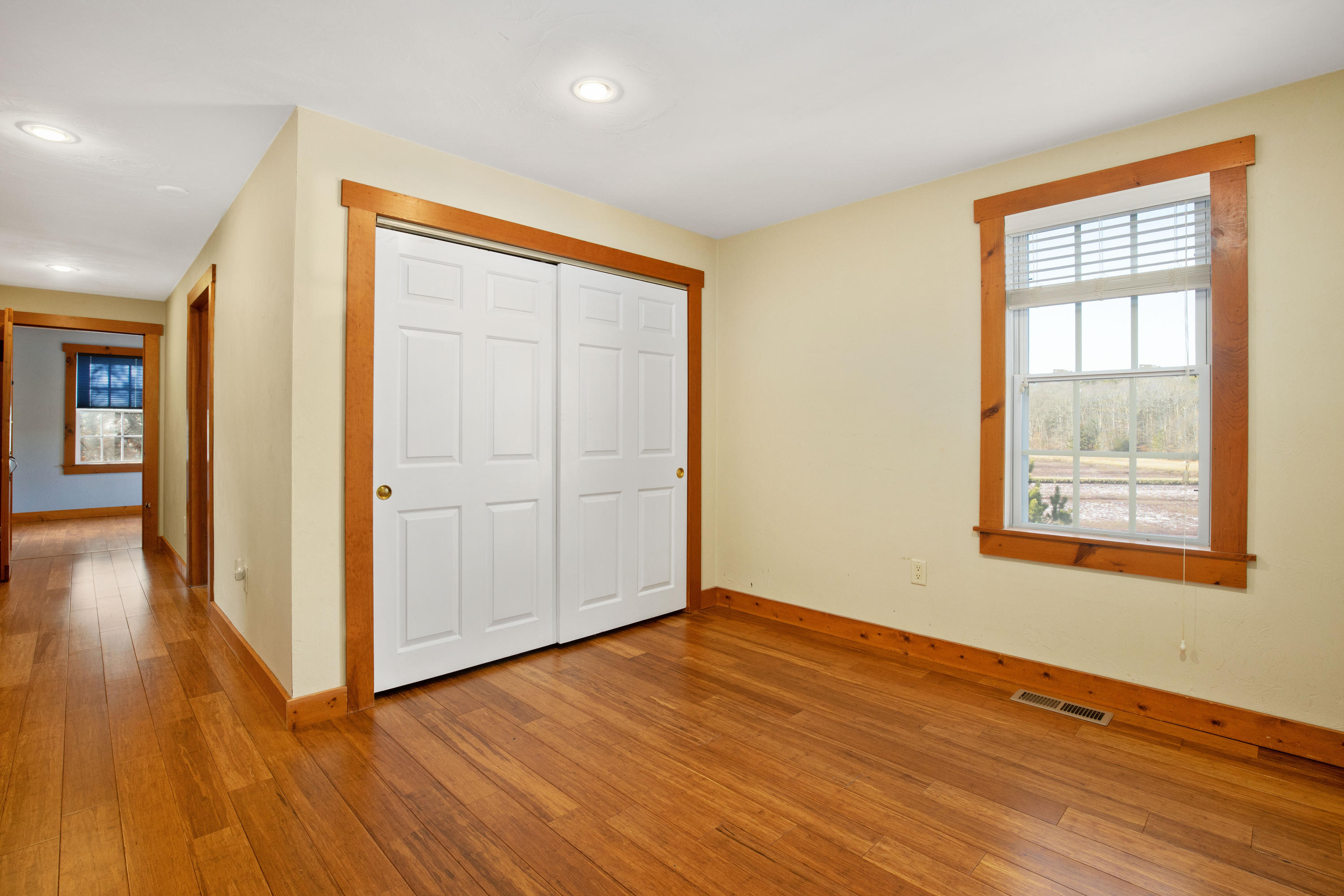 141 Bog Road Marstons Mills, MA 02648 - Photo 30 of 59 an empty room with wooden floor and windows