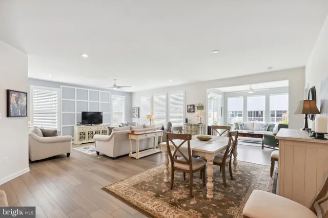 a dining room with lots of furniture and wooden floor