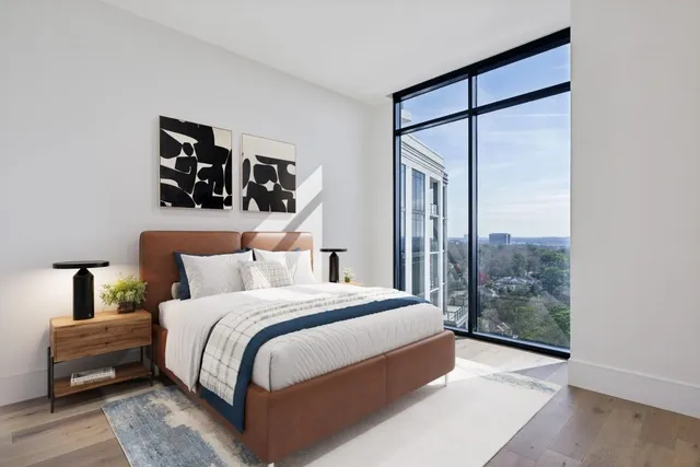 a bedroom with a large bed and a window