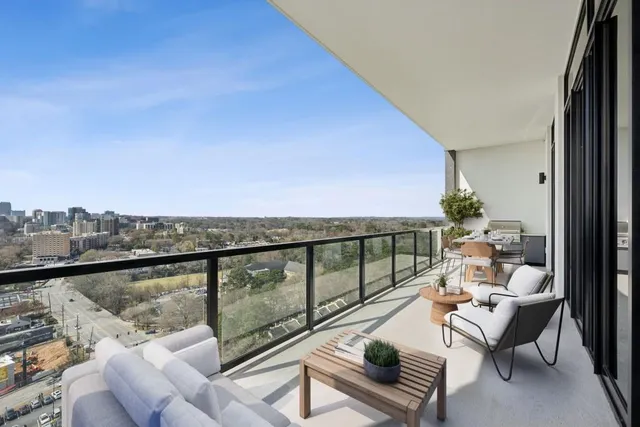 a balcony with wooden floor and outdoor seating