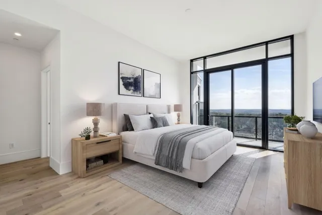 a spacious bedroom with a bed and a large window