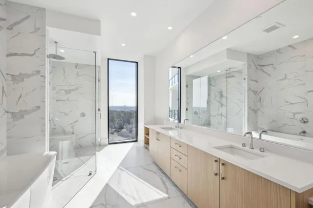 a bathroom with a double vanity sink mirror double and bathtub