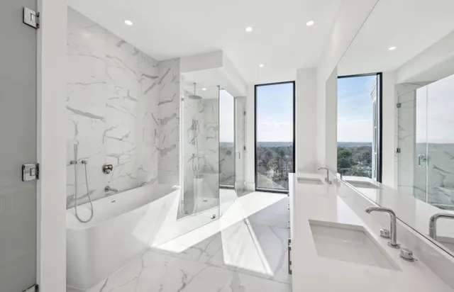 a spacious bathroom with a tub shower and sink
