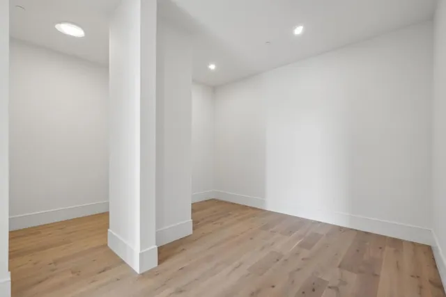 a view of a room with wooden floor