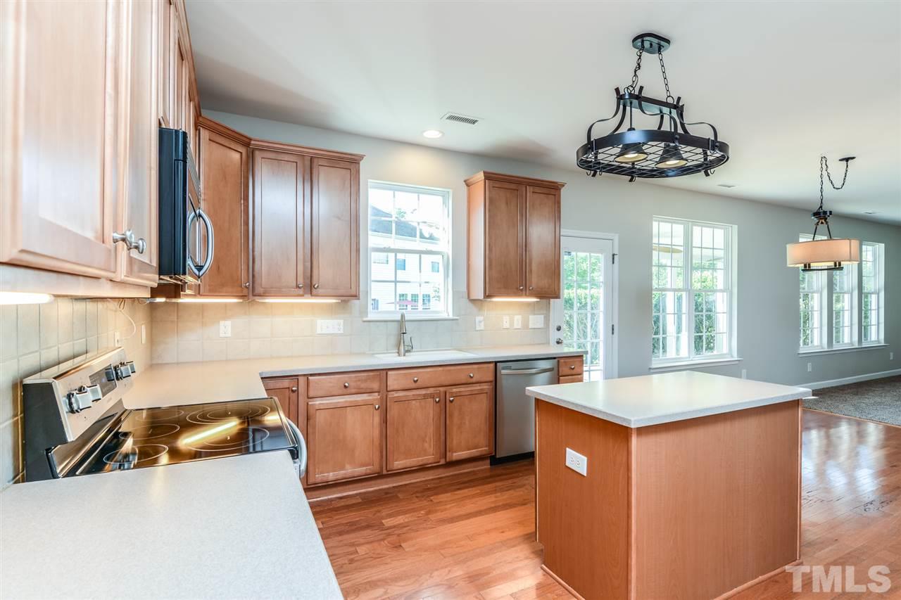 5336 Glass Ridge Road Raleigh, NC 27616 - Photo 4 of 21 a kitchen with stainless steel appliances granite countertop a sink a stove and a wooden floor