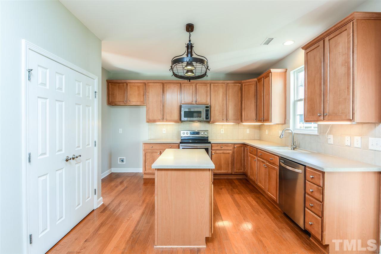 5336 Glass Ridge Road Raleigh, NC 27616 - Photo 8 of 21 a kitchen with granite countertop wooden floors granite counter tops and a window
