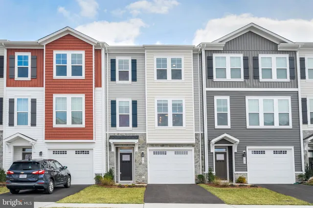 a front view of a residential apartment building with a yard