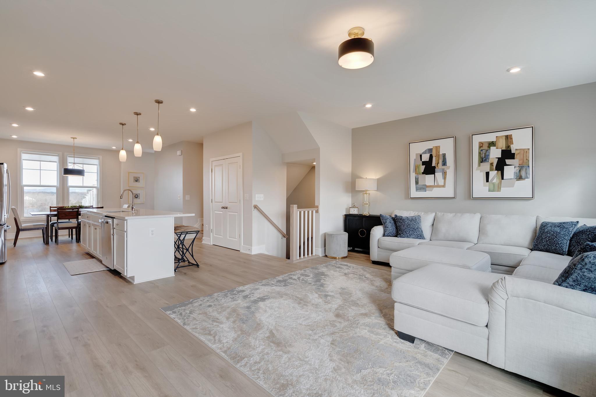105 Checkerspot Way Front Royal, VA 22630 - Photo 12 of 39 a living room with couches and kitchen view with wooden floor