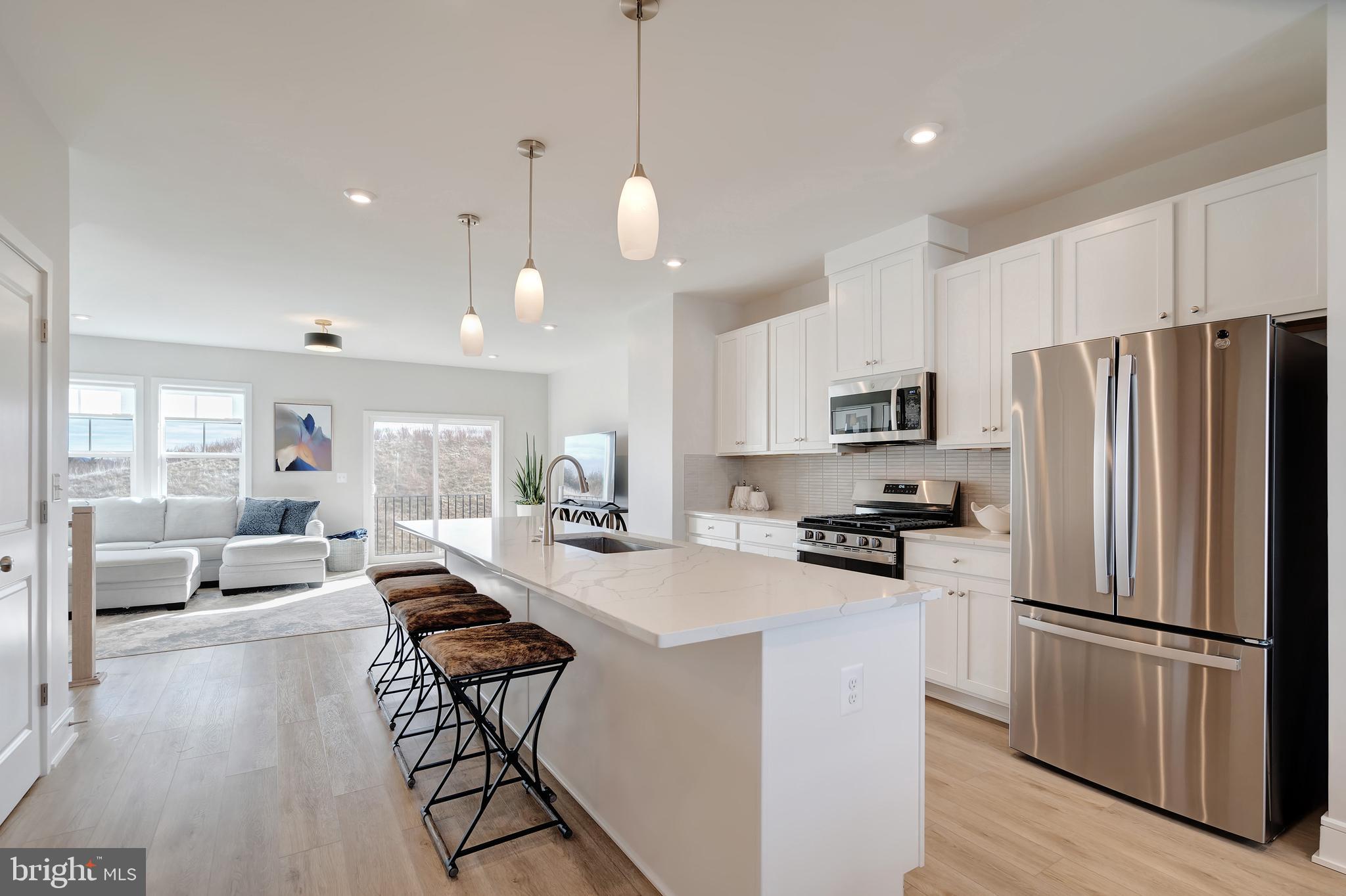 105 Checkerspot Way Front Royal, VA 22630 - Photo 17 of 39 a kitchen with stainless steel appliances a stove a refrigerator a sink a center island a dining table and chairs
