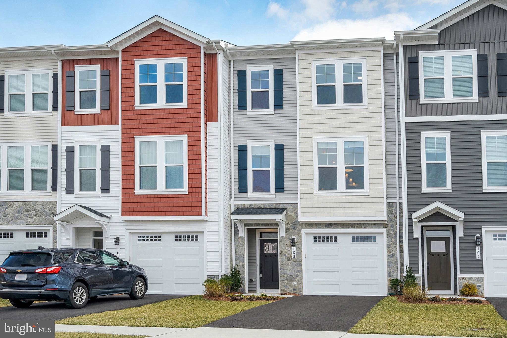 105 Checkerspot Way Front Royal, VA 22630 - Photo 2 of 39 a front view of a residential apartment building with a yard