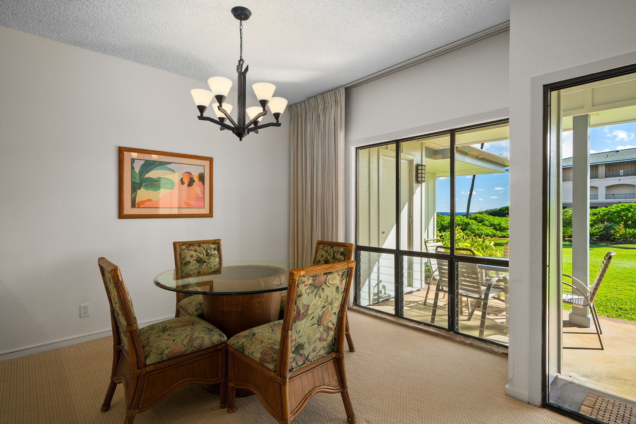 1565 Pe'e Road, Unit 418 Koloa, HI 96756 - Photo 11 of 30 a dining room with furniture a chandelier and window