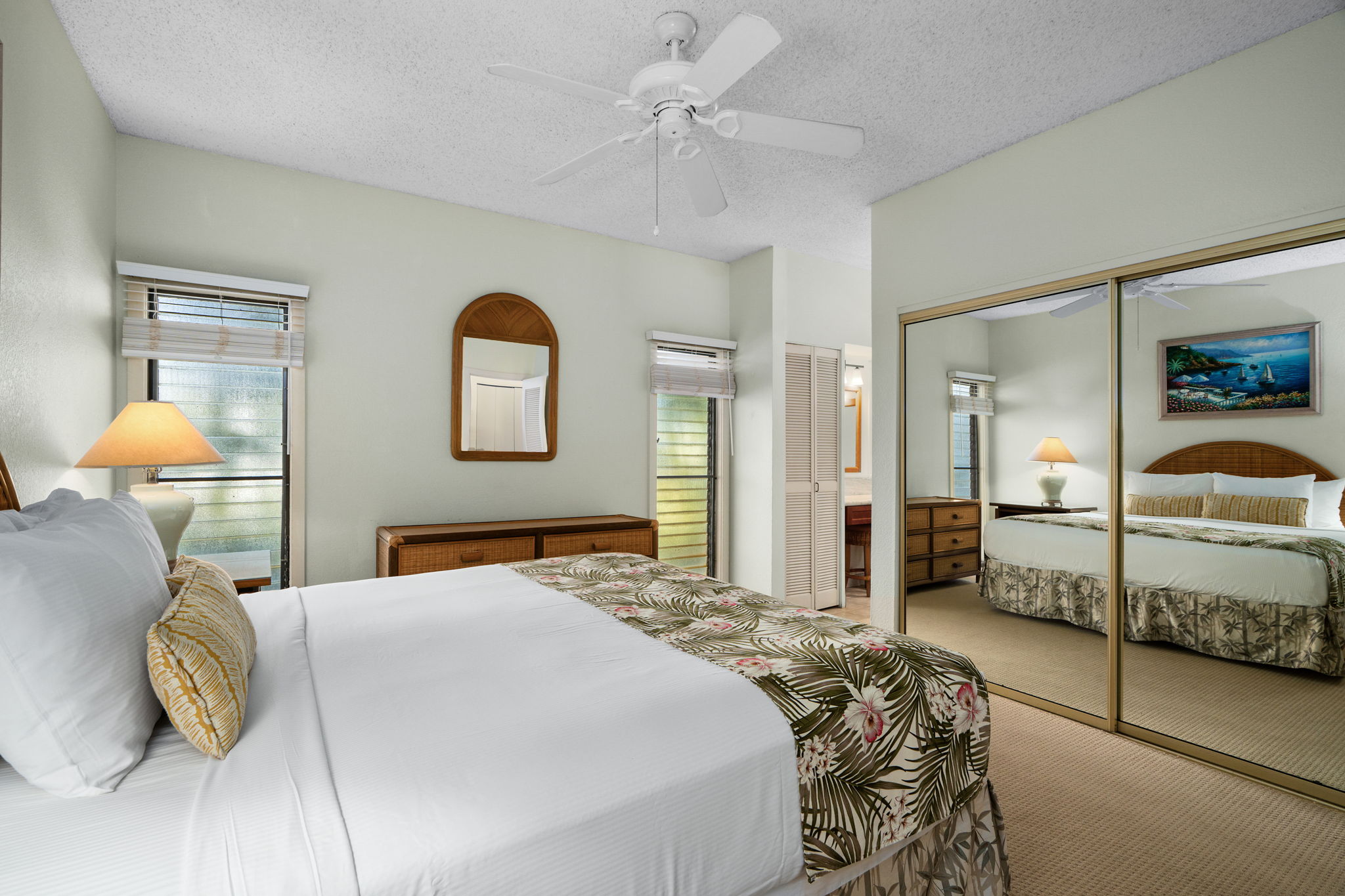 1565 Pe'e Road, Unit 418 Koloa, HI 96756 - Photo 13 of 30 a bedroom with a bed and a lamp on dresser