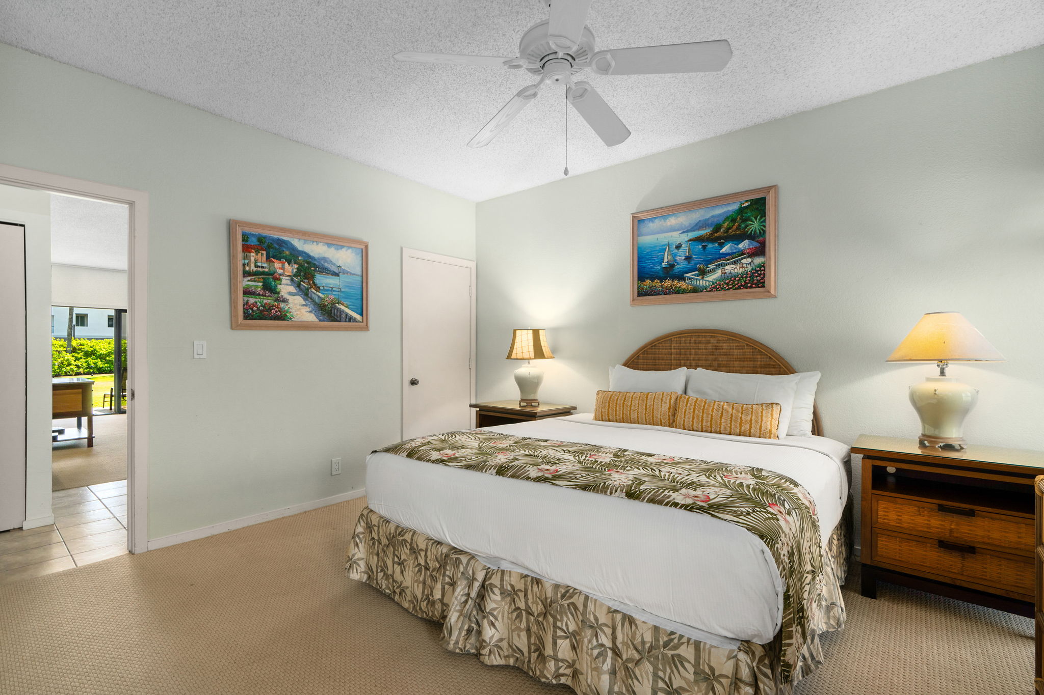 1565 Pe'e Road, Unit 418 Koloa, HI 96756 - Photo 15 of 30 a bedroom with a bed and a chandelier