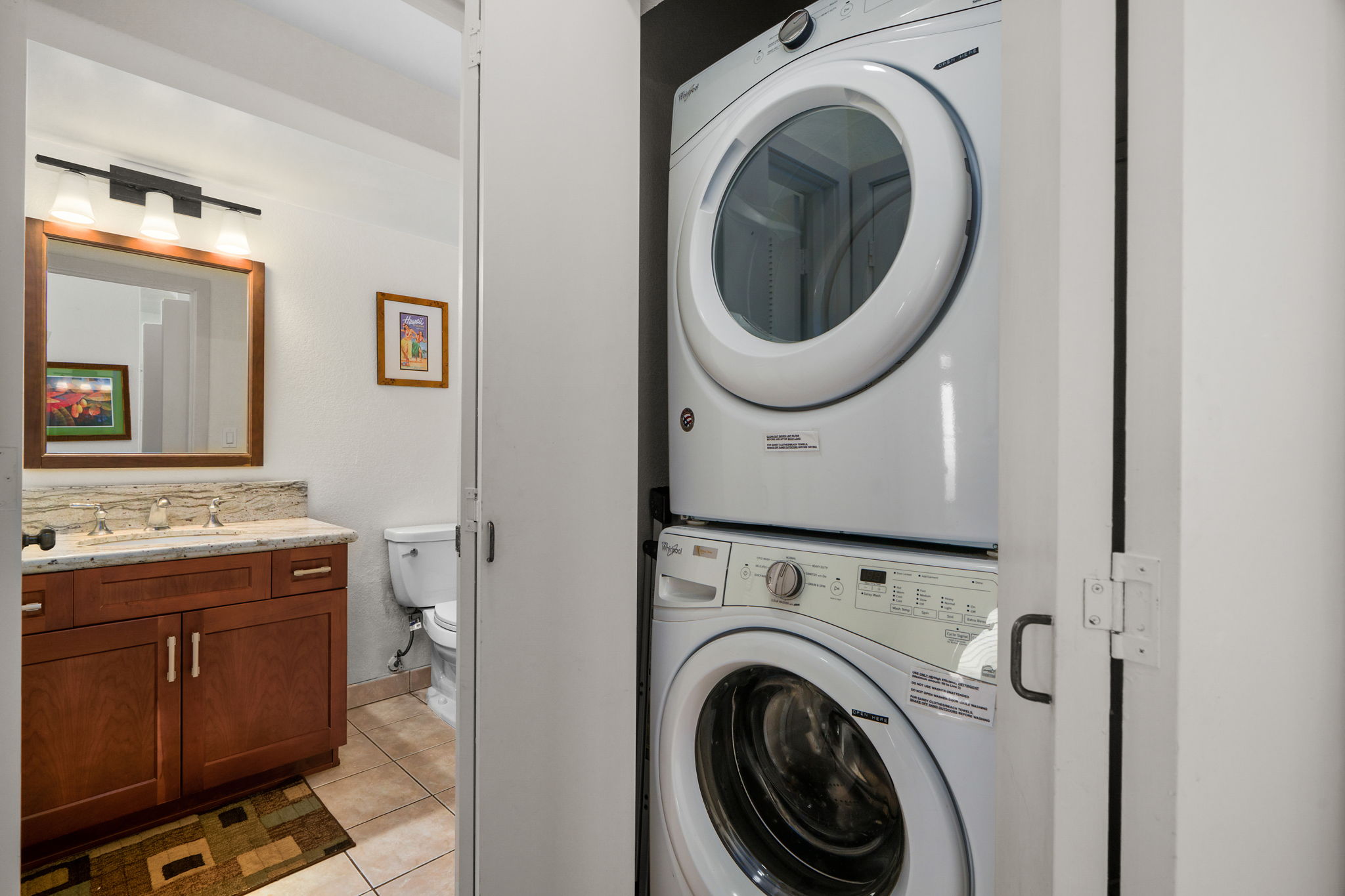 1565 Pe'e Road, Unit 418 Koloa, HI 96756 - Photo 17 of 30 a view of a hallway with washer and dryer