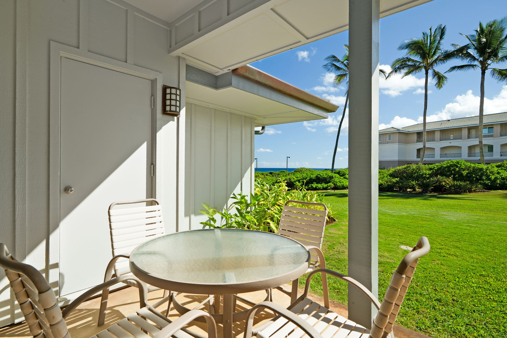 1565 Pe'e Road, Unit 418 Koloa, HI 96756 - Photo 18 of 30 a backyard of a house with table and chairs