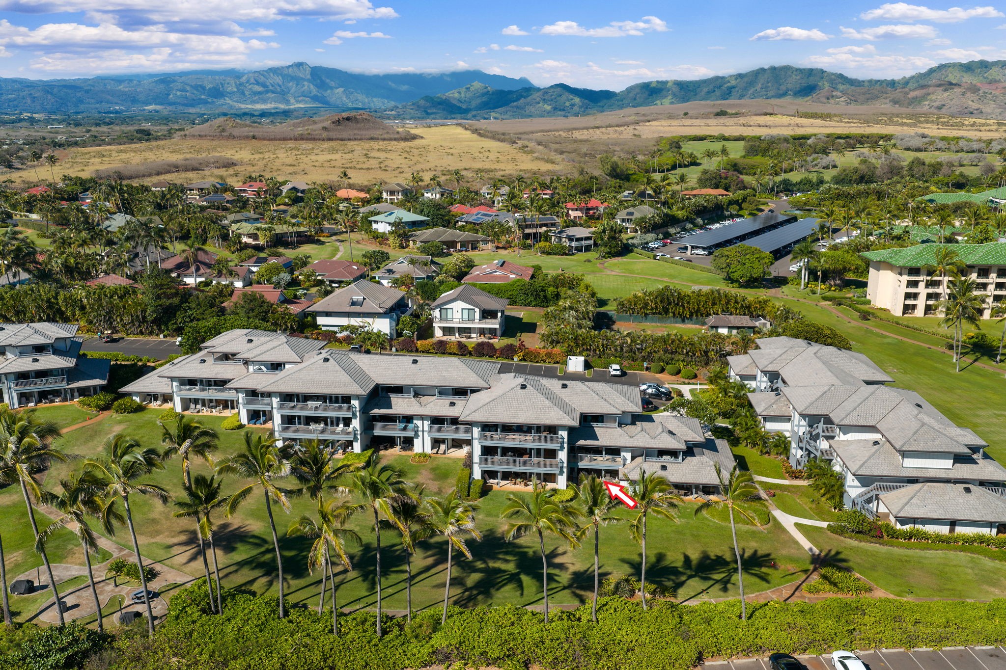 1565 Pe'e Road, Unit 418 Koloa, HI 96756 - Photo 2 of 30 a view of a city with mountains in the background