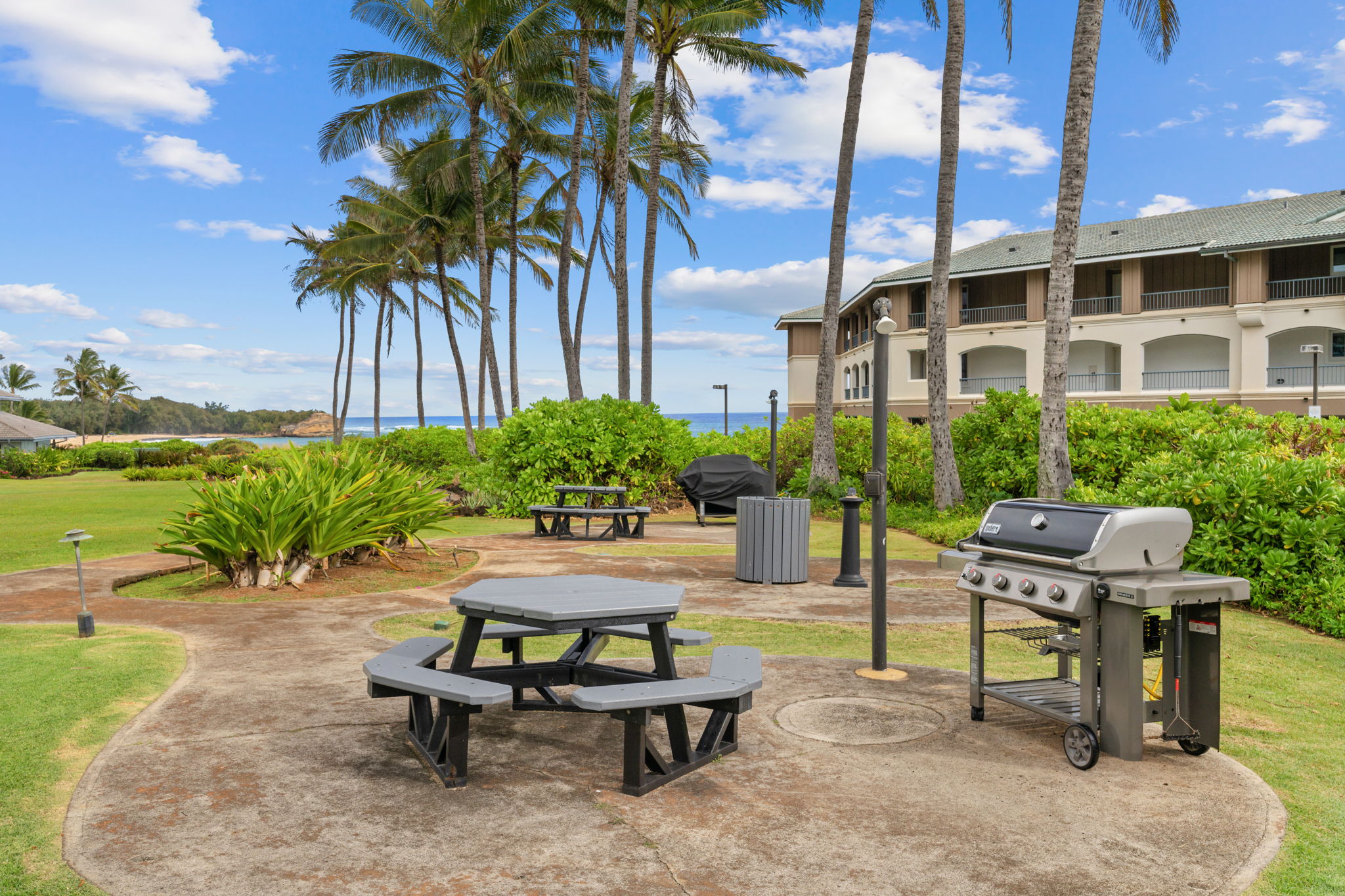1565 Pe'e Road, Unit 418 Koloa, HI 96756 - Photo 23 of 30 a swimming pool with outdoor seating and a patio