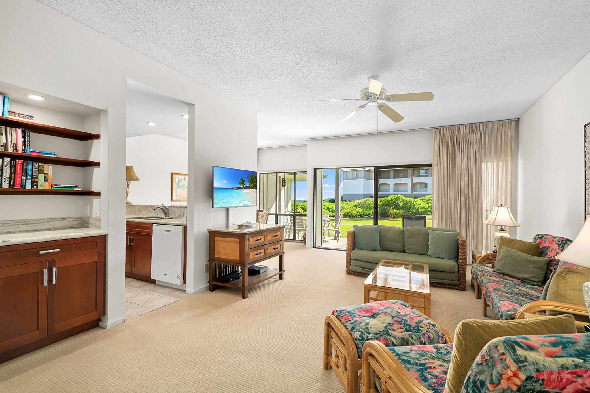 1565 Pe'e Road, Unit 418 Koloa, HI 96756 - Photo 5 of 30 a living room with furniture and a flat screen tv