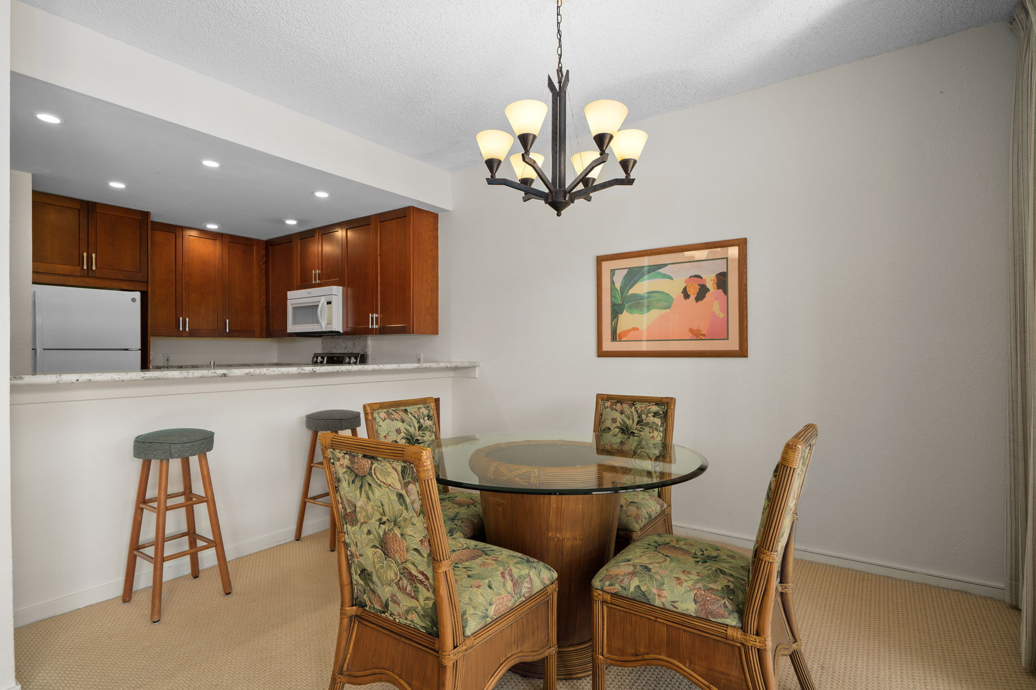 1565 Pe'e Road, Unit 418 Koloa, HI 96756 - Photo 10 of 30 a view of a dining room with furniture and chandelier