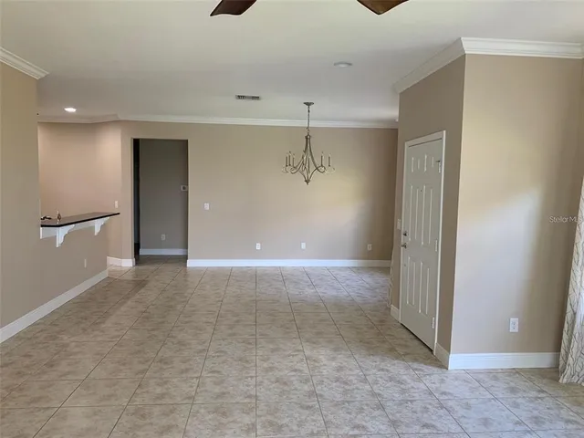 a view of a big room with closet and windows