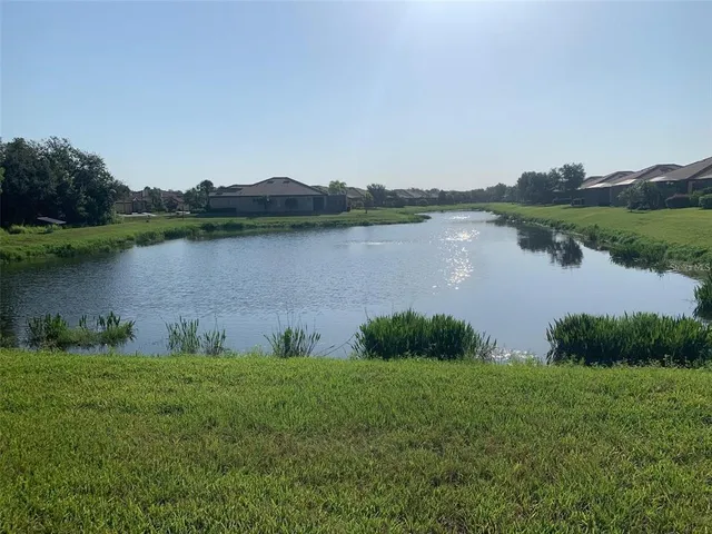 a view of a lake with houses in the back