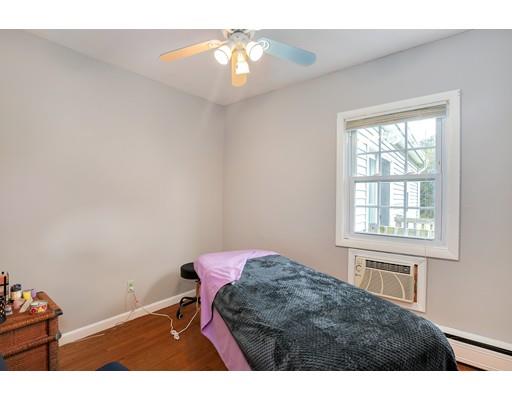 65 Barnett Road Sutton, MA 01590 - Photo 9 of 23 a bedroom with a bed window and a chandelier