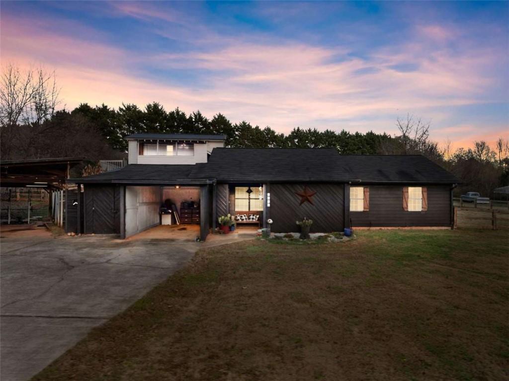 1142 Lewis Roberts Road Jefferson, GA 30549 - Photo 1 of 1 a front view of a house with a yard and garage