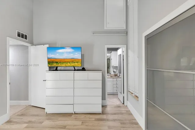 a front view of a house with garden and trees