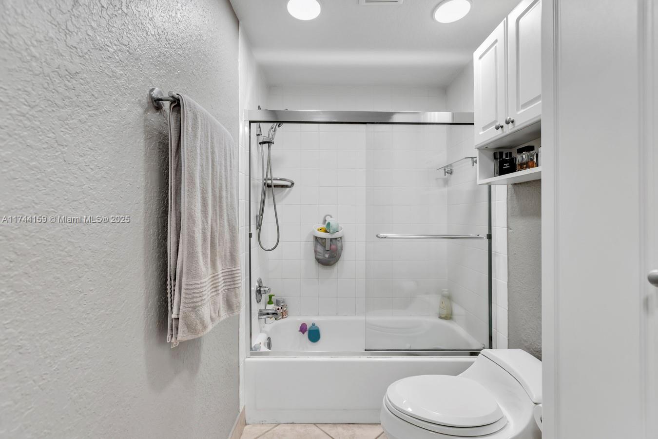 1161 Northwest 13th Street, Unit 4 Boca Raton, FL 33486 - Photo 17 of 39 a bathroom with a toilet and a shower