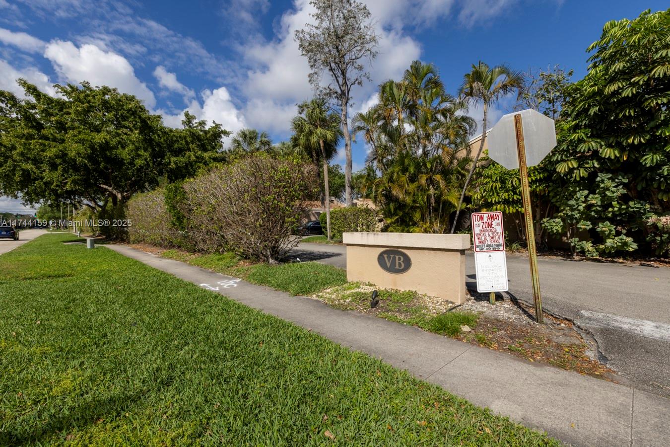 1161 Northwest 13th Street, Unit 4 Boca Raton, FL 33486 - Photo 23 of 39 a front view of a house with garden and trees