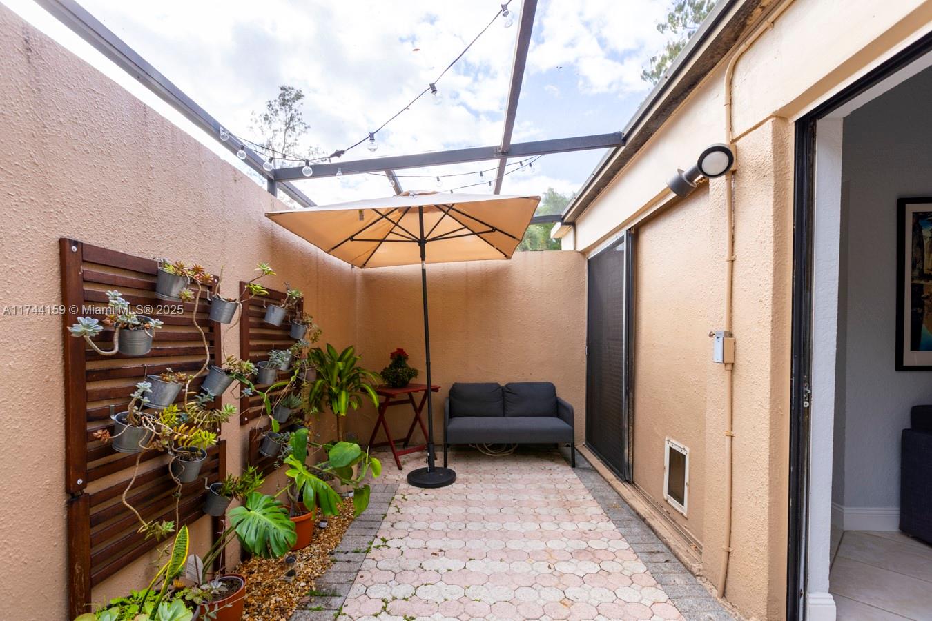 1161 Northwest 13th Street, Unit 4 Boca Raton, FL 33486 - Photo 7 of 39 a view of a porch with furniture and a yard